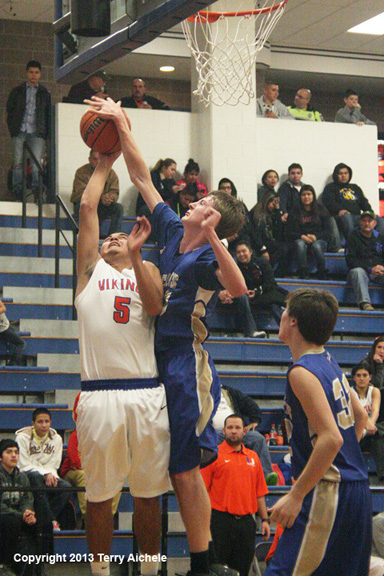 LEFT - Juan Coria of Umatilla, number 5 in white, attempts a shot while ...